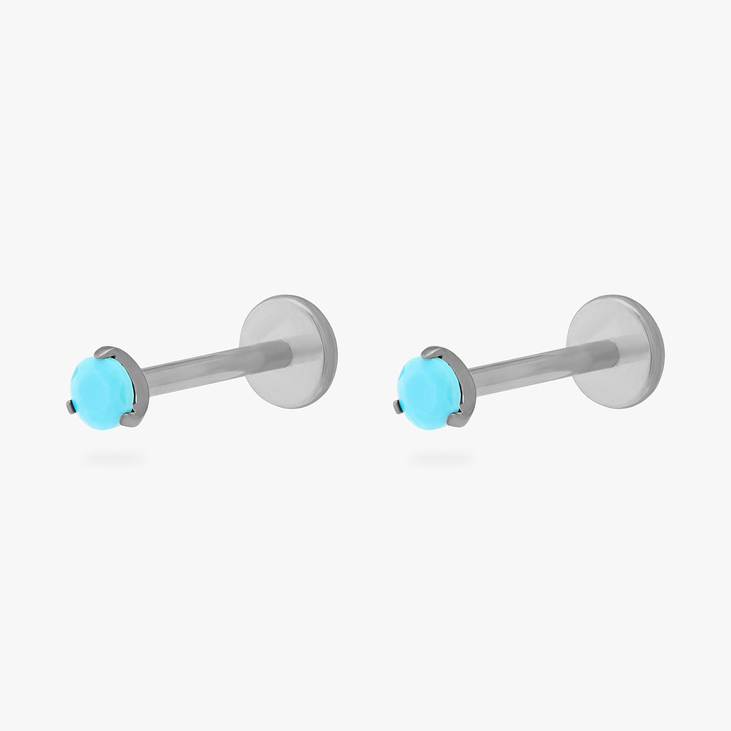 This is a pair of silver toned titanium flatback studs with mini turquoise cz stones. [pair] color:null|turquoise