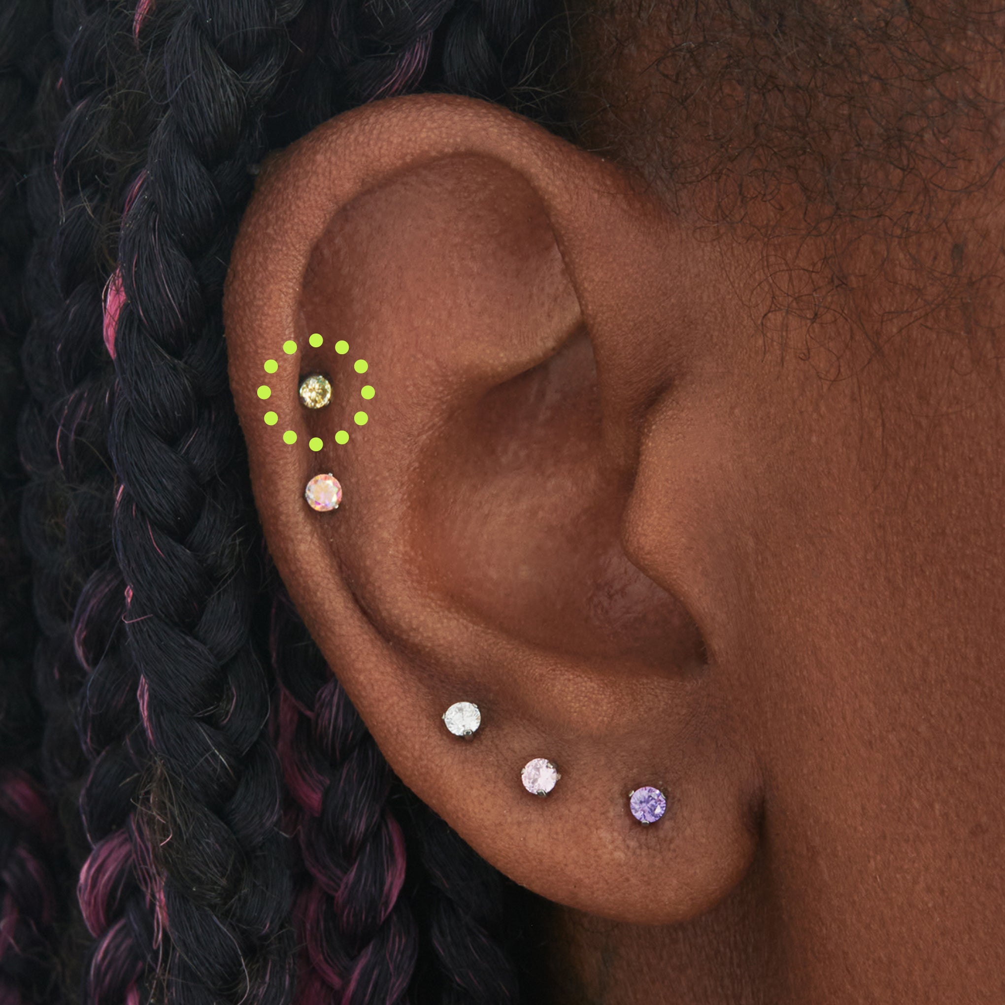 on ear featuring a titanium flatback stud with a 2.5mm yellow cz stone that comes with 2 backs in 6mm and 8mm lengths [hover] color:null|silver/yellow