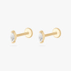 This is an image of a pair of 14k gold flatbacks with marquise settings and clear stones. [pair] color:null|14k gold/clear