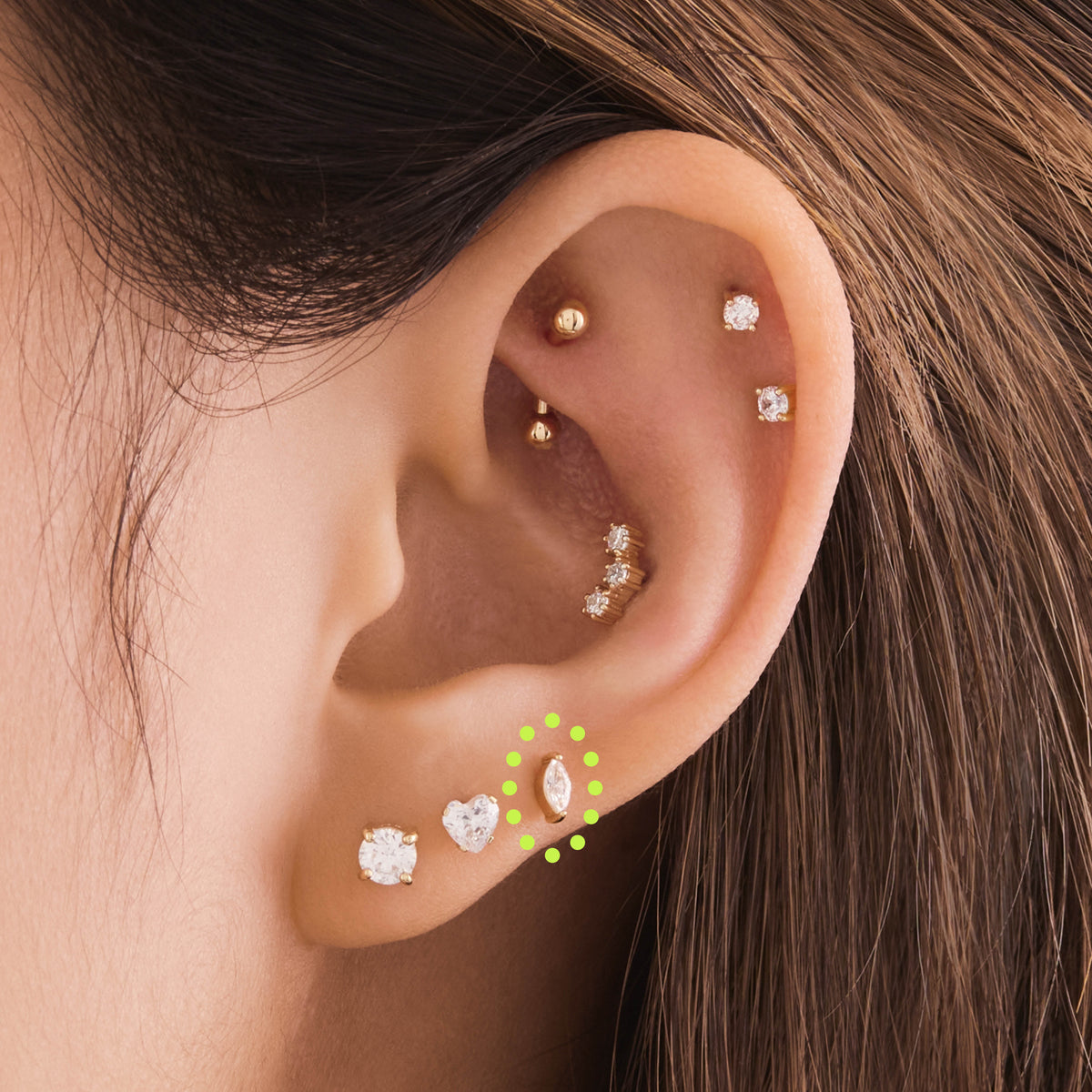 This is an image of a 14k gold flatback with a marquise setting and clear stone on ear. - Alternative view 1