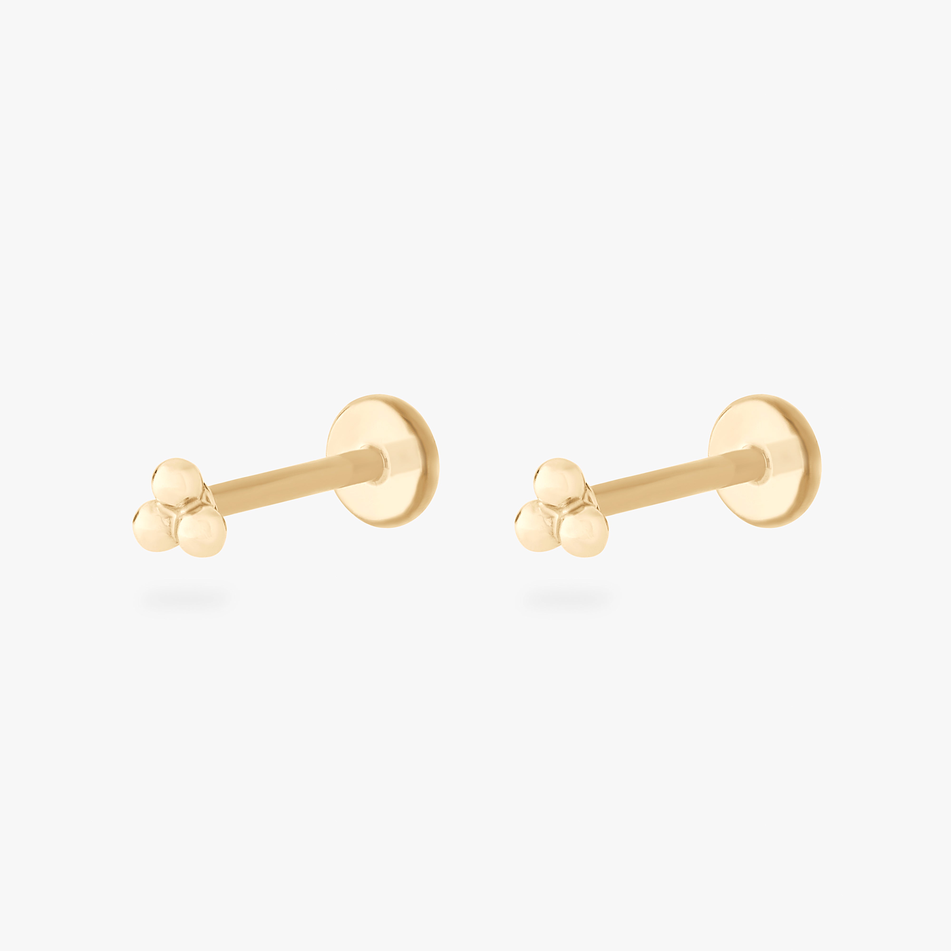 This is an image of a pair of 14k gold flatback studs with 3 gold beads creating a triangle shape on each flatback stud. [pair] color:null|14k gold
