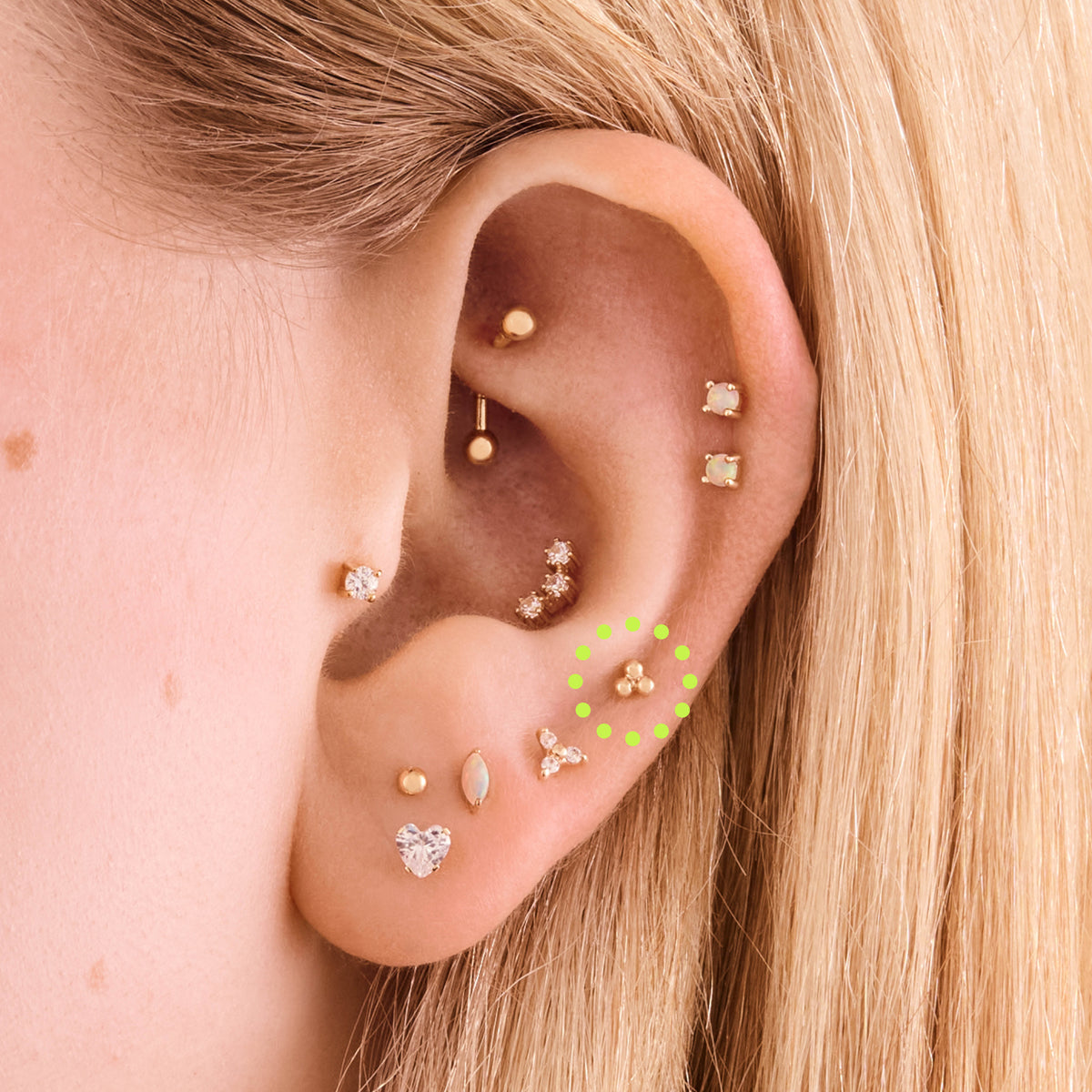 This is an image of a 14k gold flatback stud with 3 gold beads creating a triangle shape on ear. - Alternative view 1