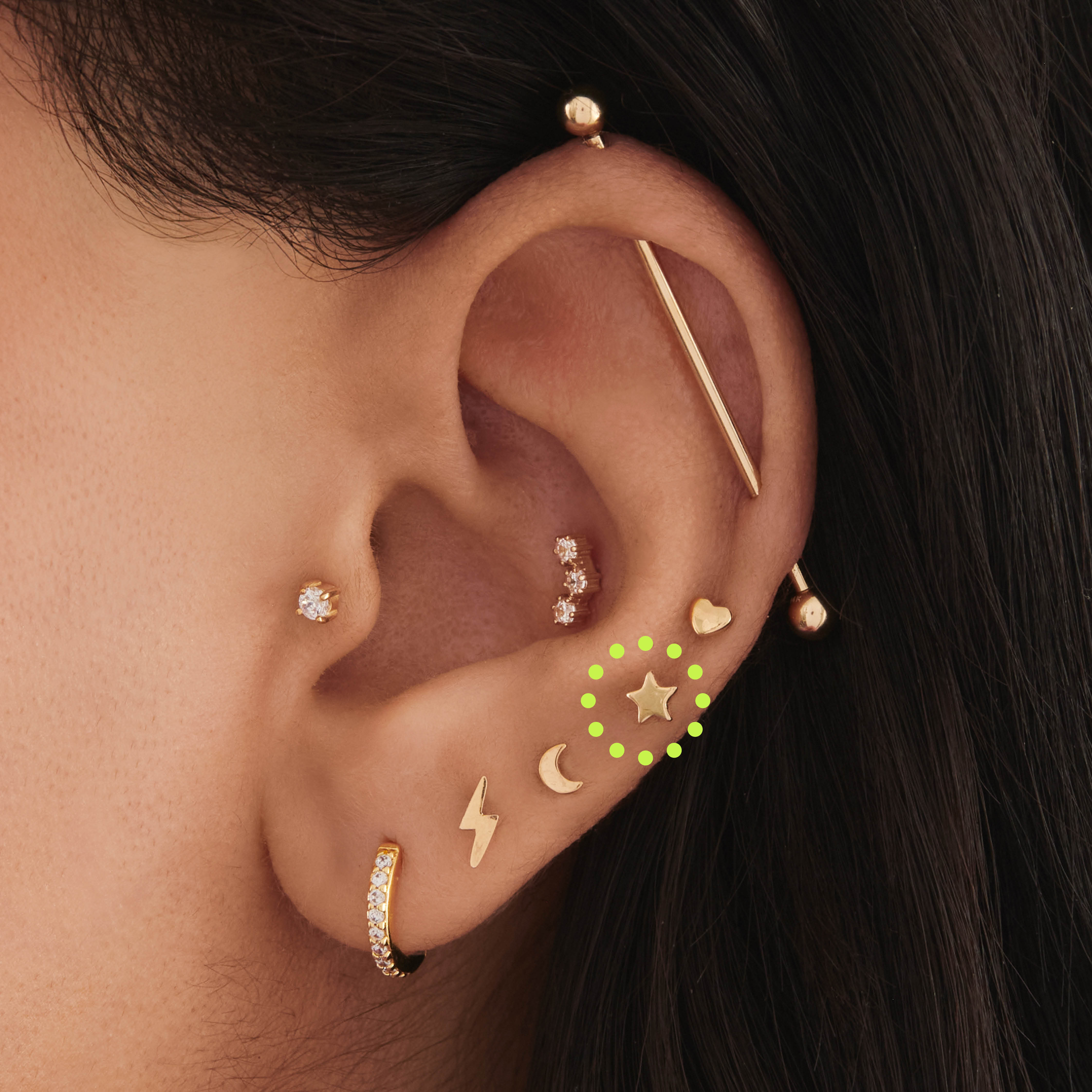 This is an image of a 14K gold flatback stud that is in the shape of a star on ear. [hover] color:null|14k gold