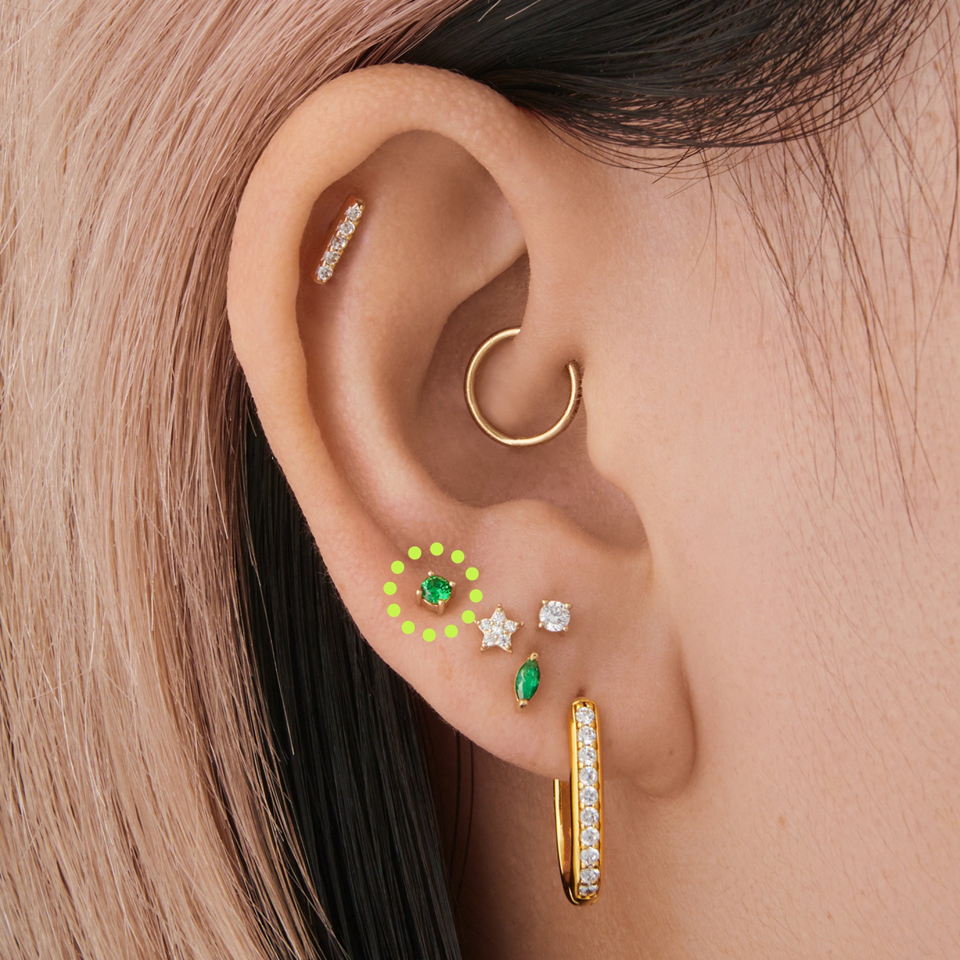This is an image of a 14k gold flatback with a 2.5mm cz setting and green cz stone on ear. [hover] color:null|14k gold|14k gold/green