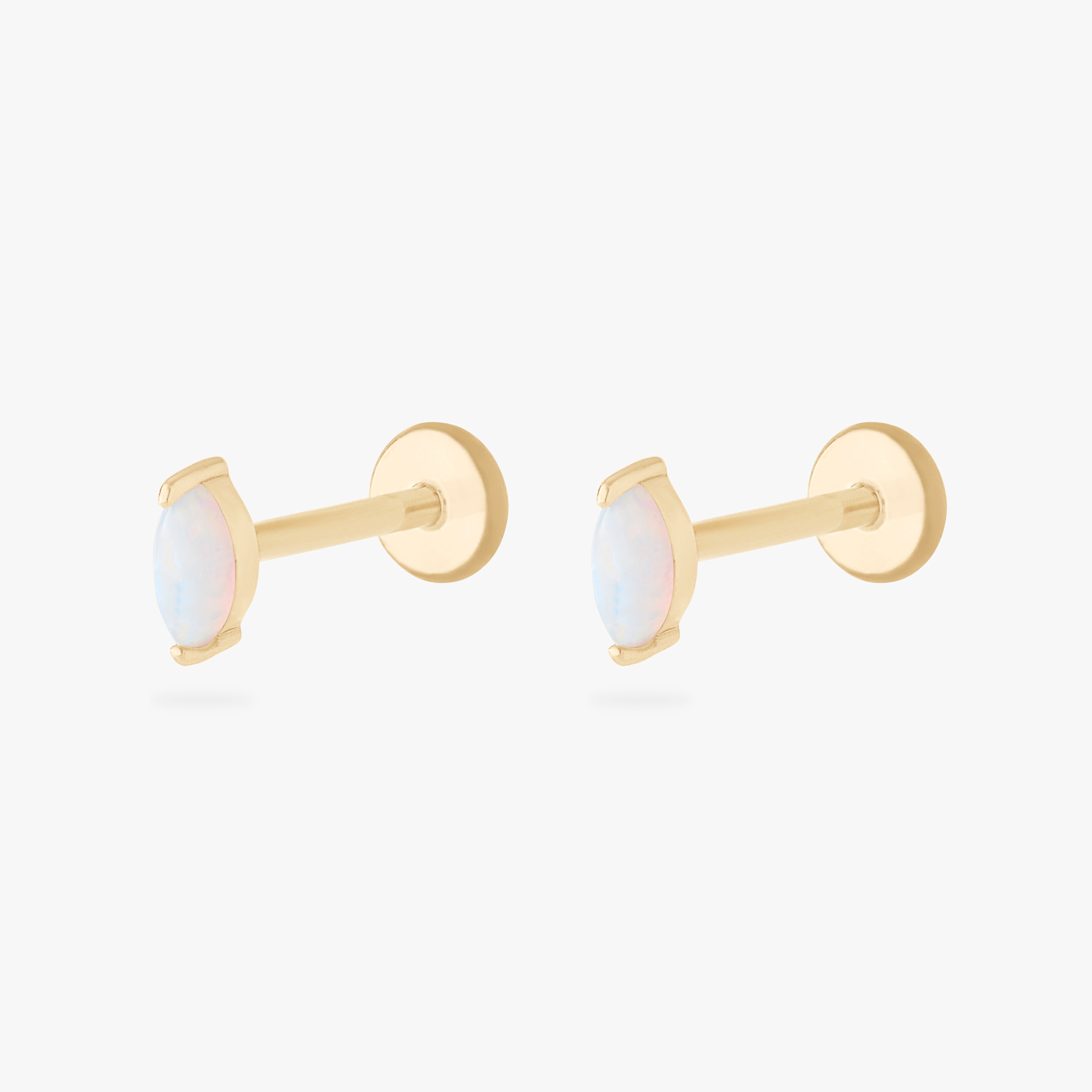 This is an image of a pair of 14k gold flatbacks with marquise settings and opal stones. [pair] color:null|14k gold