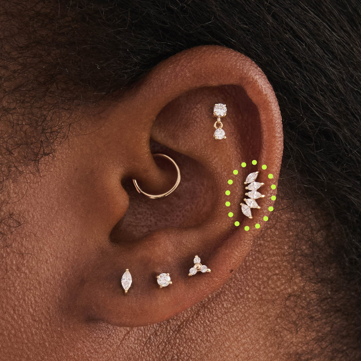 This is an image of a 14k gold flatback with a crown marquise cz setting and clear cz stone on ear. - Alternative view 1