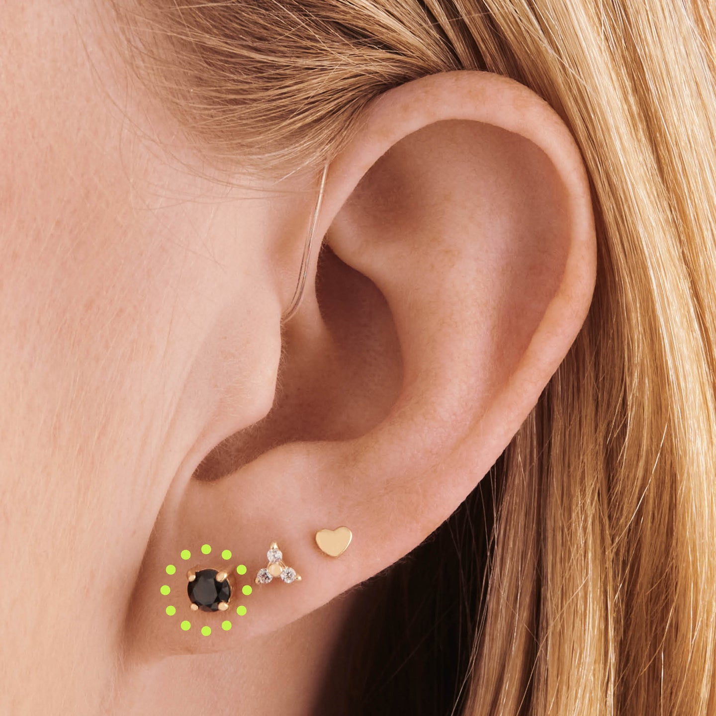 on ear featuring a 14k 4mm cz flatback stud with a black cz stone [hover] color:null|gold/black