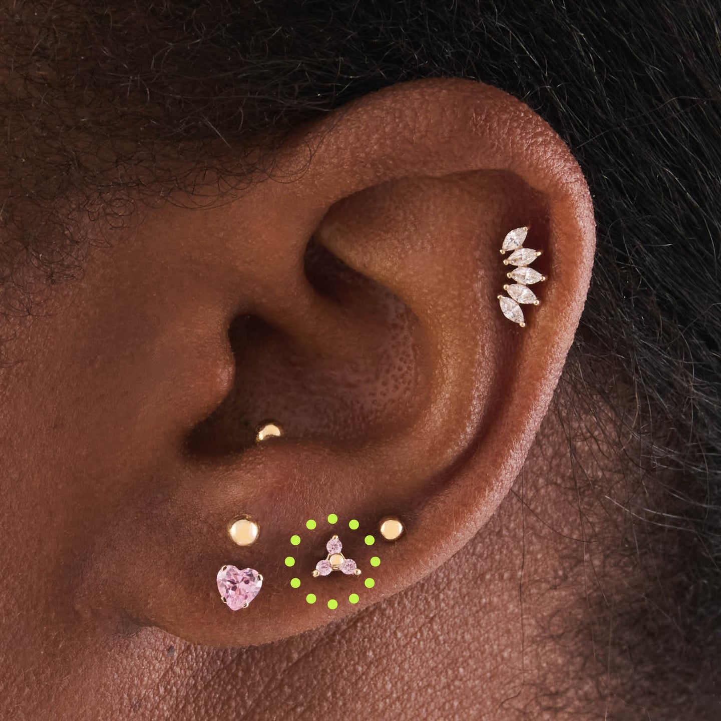 on ear featuring a trio of 3 mini cz stones in pink set in a 14k flatback stud [hover] color:null|gold/pink