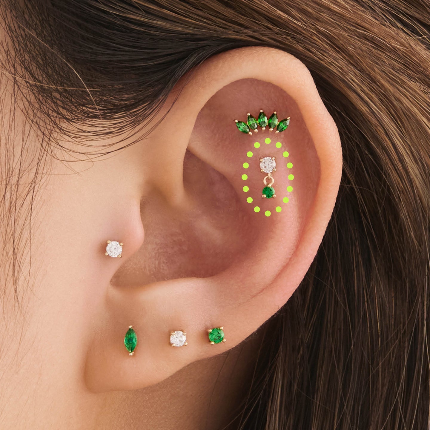 on ear featuring a 14k cz dangle flatback stud with a clear and green cz stone [hover] color:null|gold/green