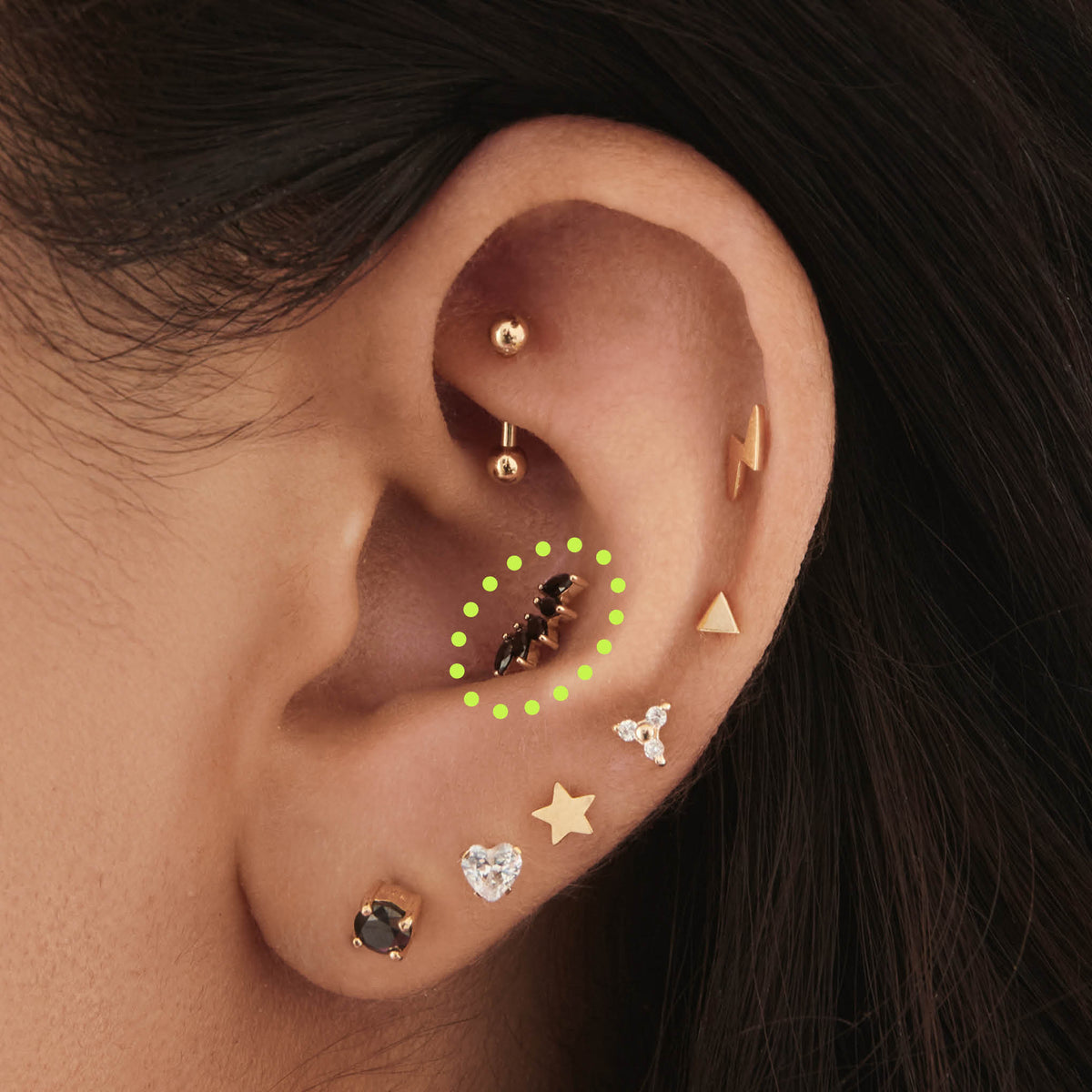 This is an image of a 14k gold flatback with a crown marquise cz setting and black cz stone on ear. 