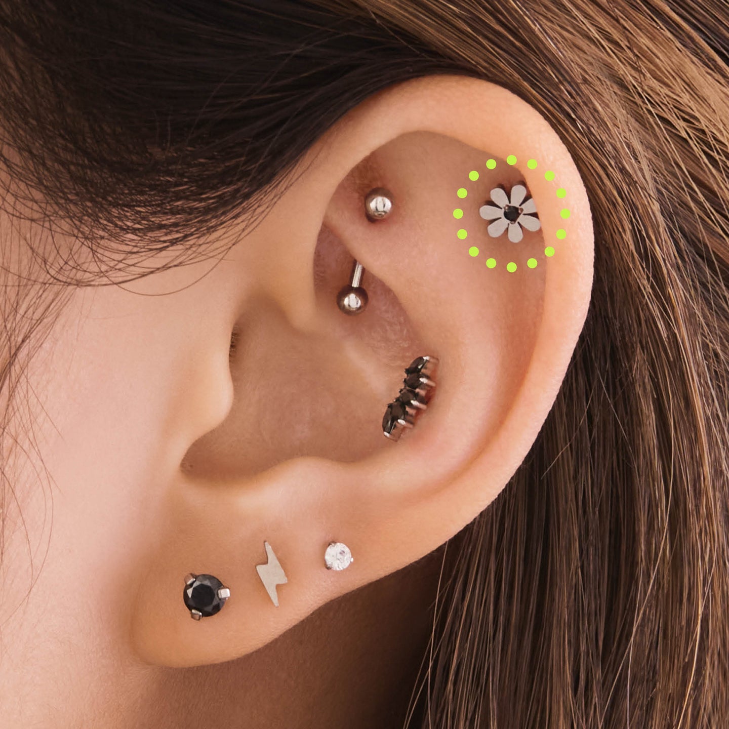 on ear featuring a titanium cz daisy flatback stud with a mini black cz in the center [hover] color:null|silver/black