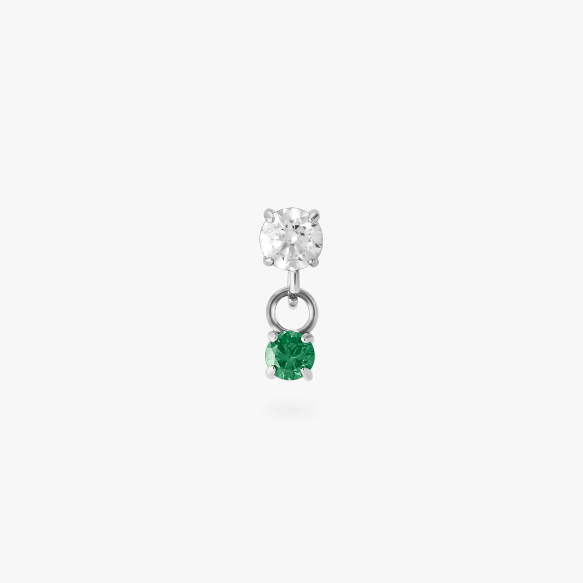 This image is a silver toned titanium flatback stud that features a larger crystal CZ stone with a smaller green CZ stone dangling from it against a white background.