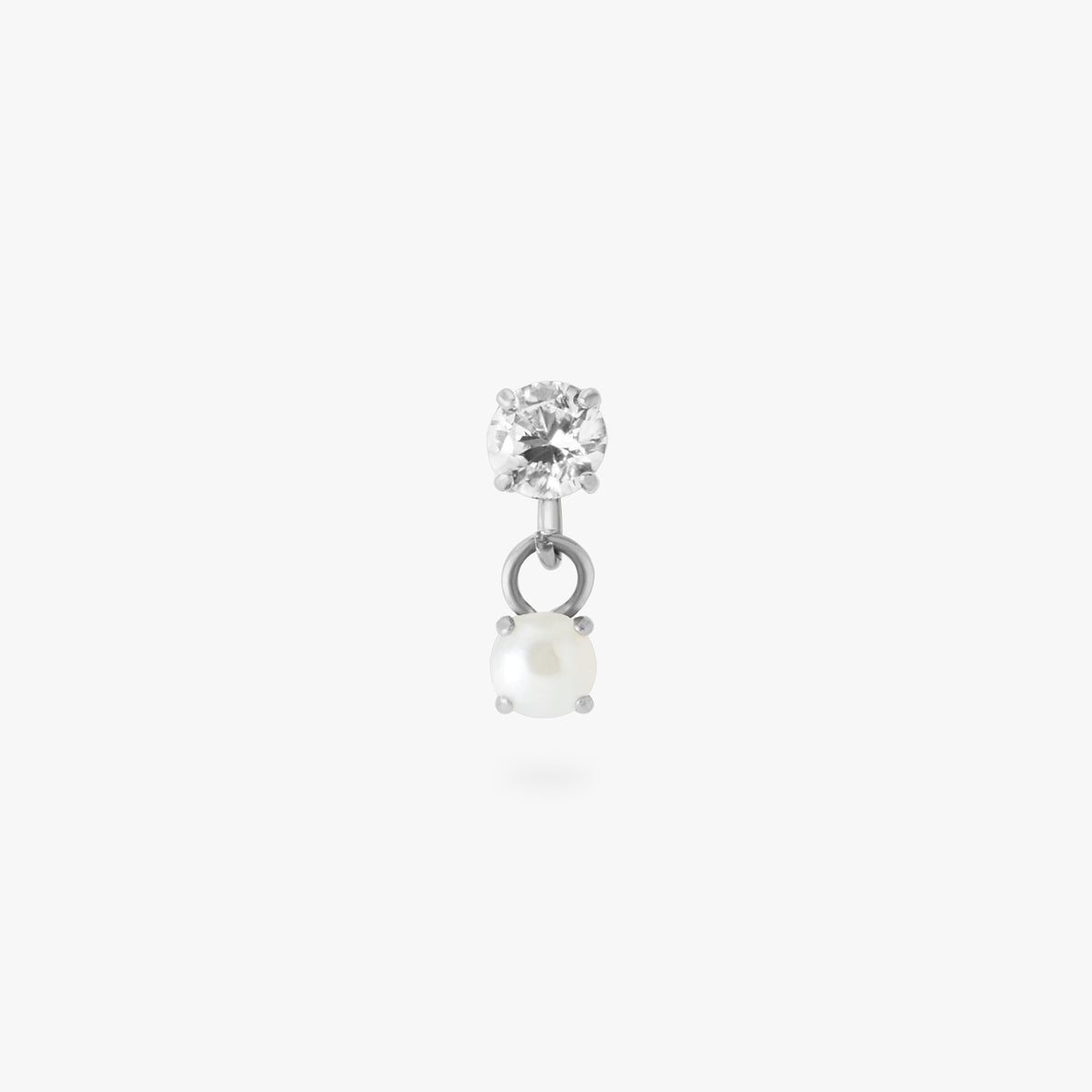 This image is a silver toned titanium flatback stud that features a larger crystal CZ stone with a smaller pearl stone dangling from it against a white background.