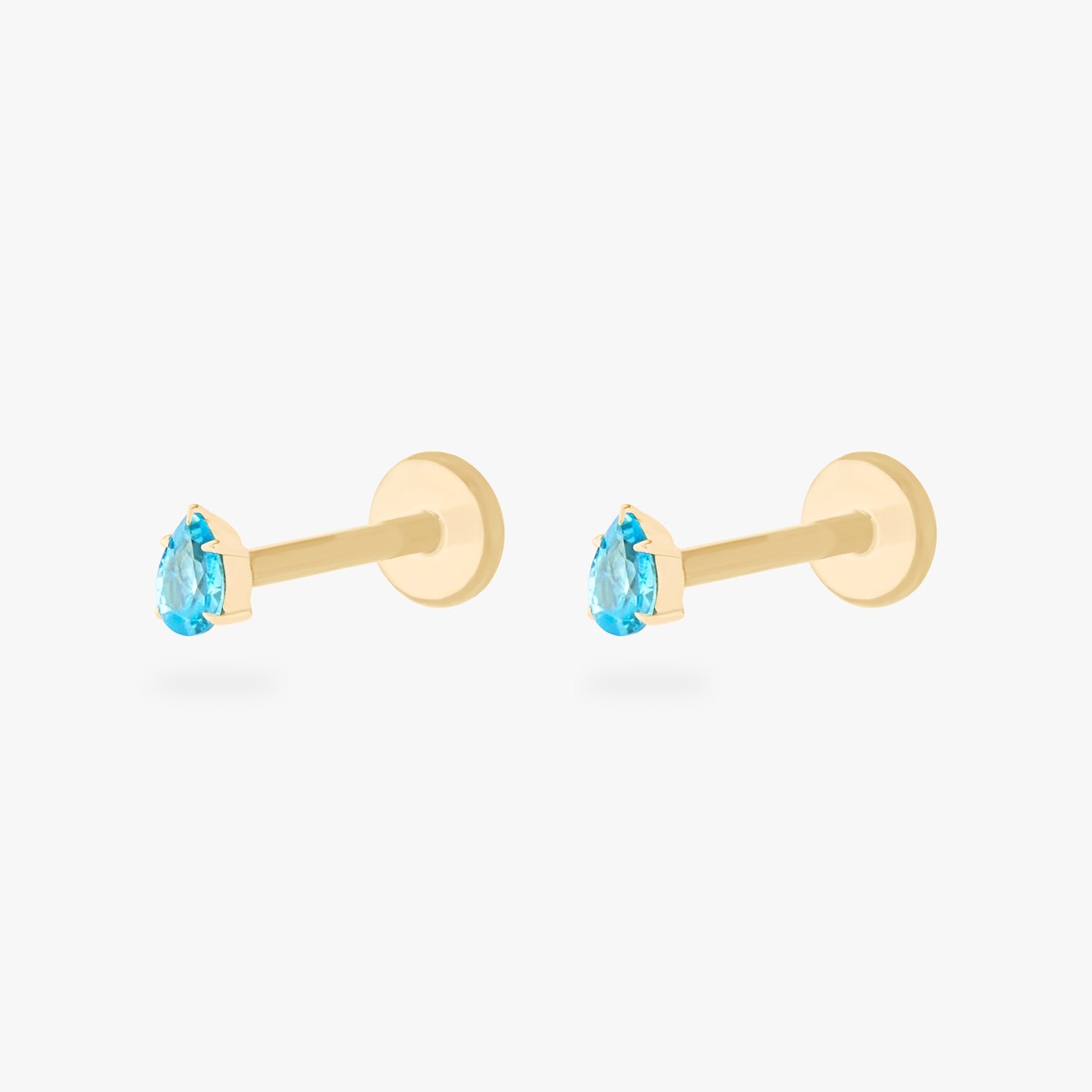 This is a pair of 14K gold flatback studs with pear shaped aquamarine cz stones. [pair] color:null|aquamarine