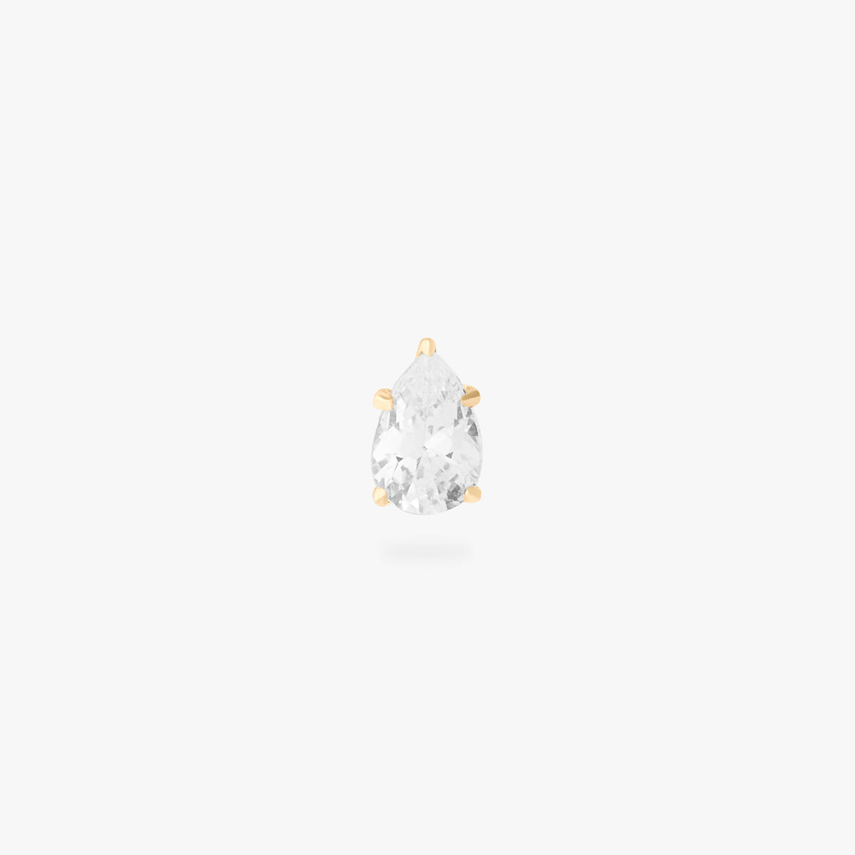 This image is a 14K gold flatback stud with a pear shaped crystal cz stone against a white background. 