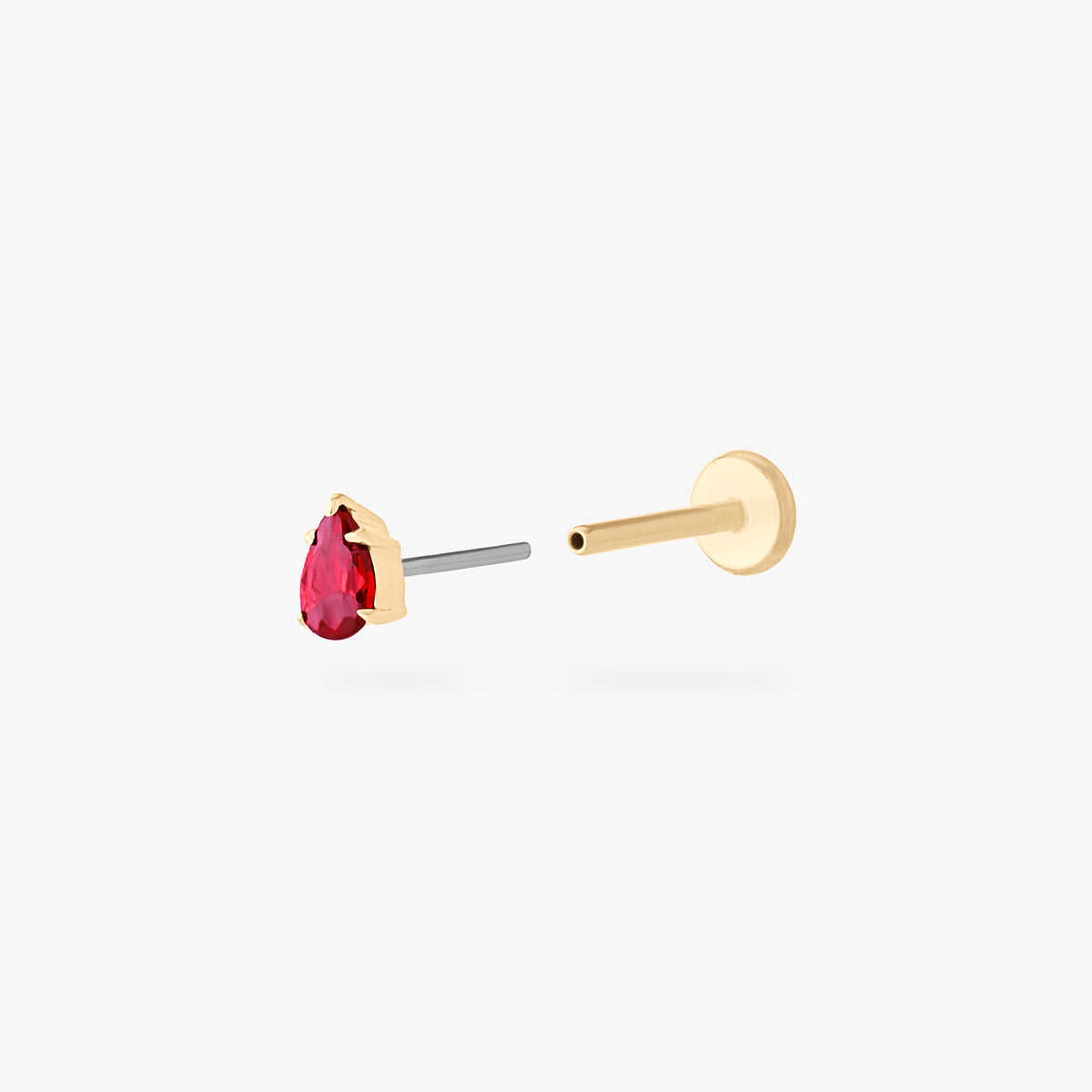 This is an image of a 14K gold flatback stud with a pear shaped garnet cz stone against a white background. This image shows the flatback stud pieces separated. 
