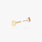 This is an image of a 14K gold flatback stud with a pear shaped garnet cz stone against a white background. This image shows the flatback stud pieces separated, and focuses on the Studs "S" on the flatback post.