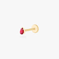 This is an image of a 14K gold flatback stud with a pear shaped garnet cz stone against a white background.