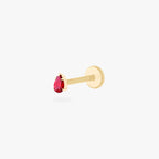 This is an image of a 14K gold flatback stud with a pear shaped garnet cz stone against a white background.