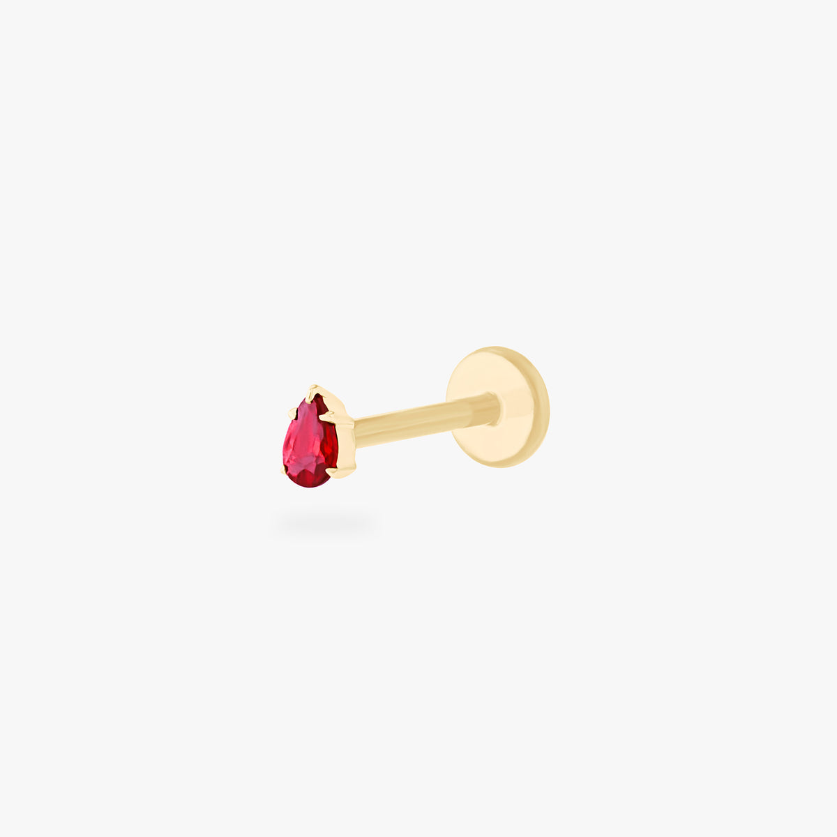 This is an image of a 14K gold flatback stud with a pear shaped garnet cz stone against a white background.