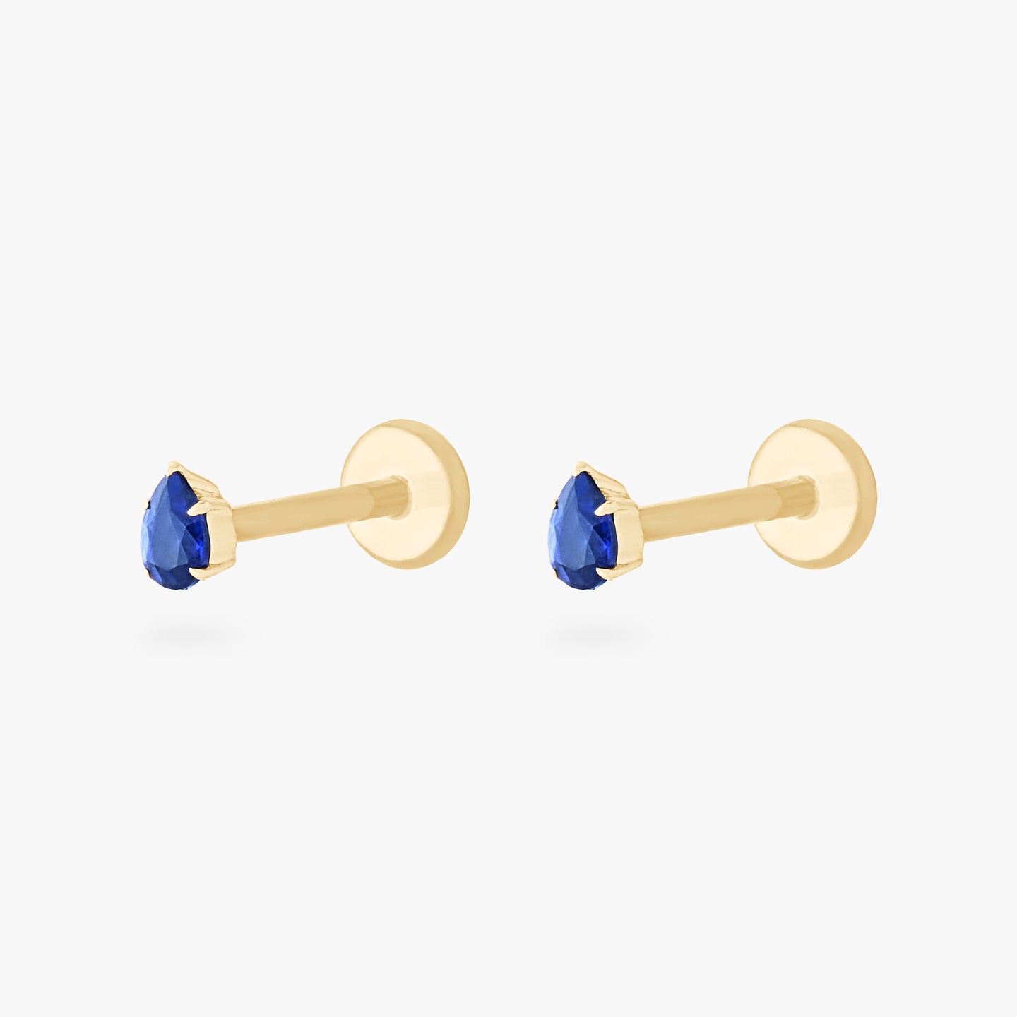 This is a pair of 14K gold flatback studs with pear shaped sapphire cz stones. [pair] color:null|sapphire