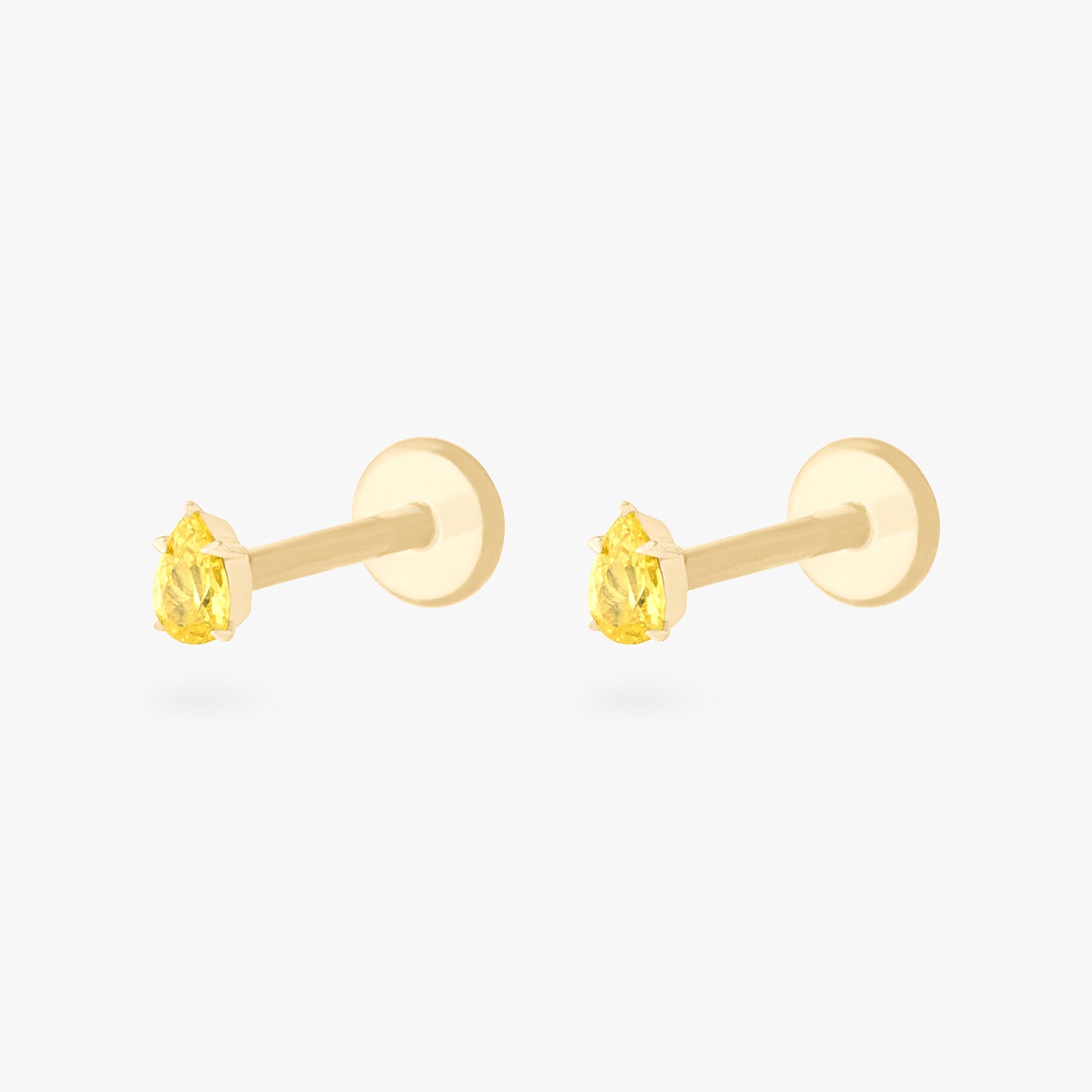 This is a pair of 14K gold flatback studs with pear shaped topaz cz stones. [pair] color:null|topaz