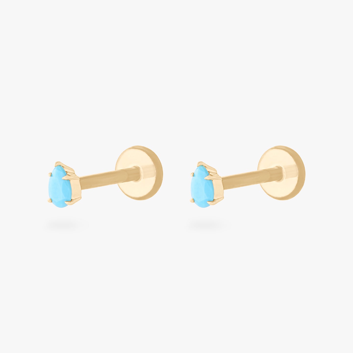 This is a pair of 14K gold flatback studs with pear shaped turquoise cz stones. [pair] color:null|turquoise