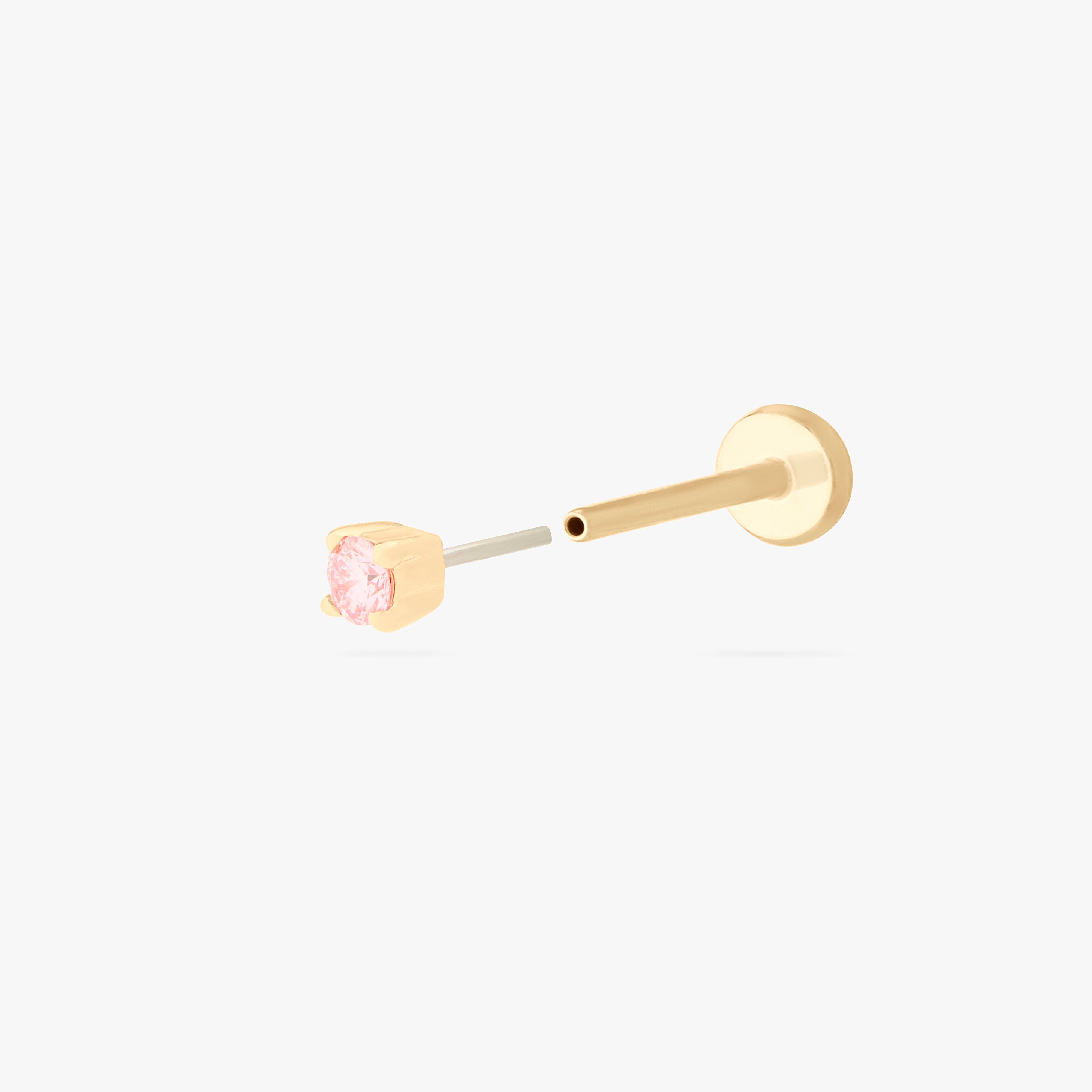 This image shows a flatback stud made of 14K gold with a round pink diamond stone and the gold-toned labret back removed. - Alternative view 2