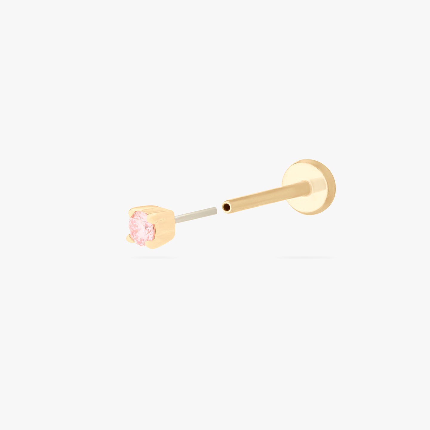 This image shows a flatback stud made of 14K gold with a round pink diamond stone and the gold-toned labret back removed. color:null|pink|gold/pink