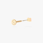 This image shows a flatback stud made of 14K gold with a round pink diamond stone facing backwards and the gold-toned labret back removed. 
