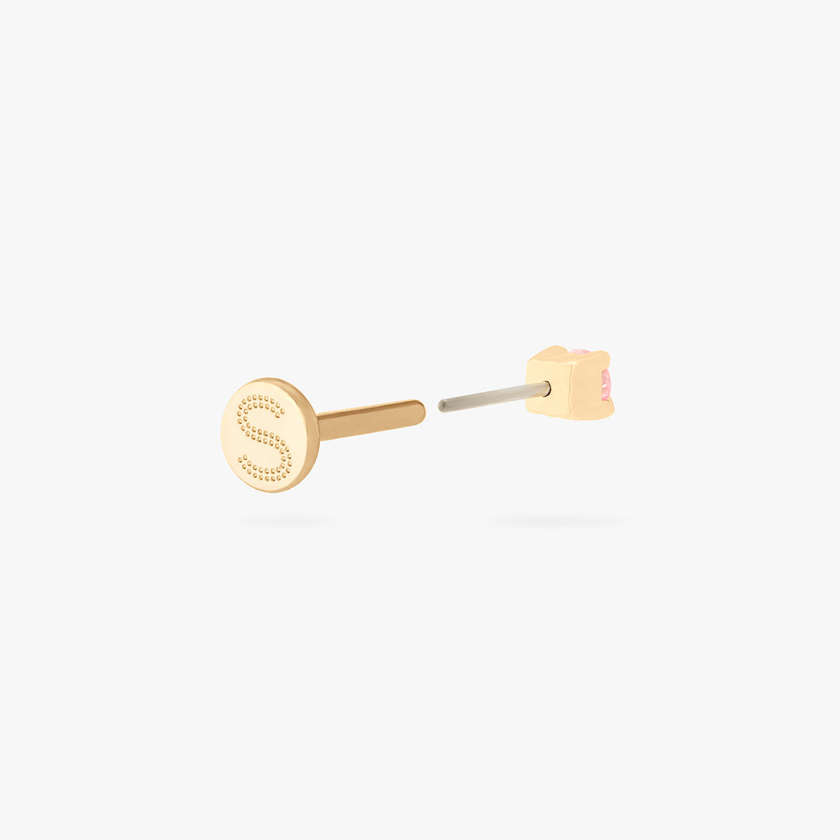 This image shows a flatback stud made of 14K gold with a round pink diamond stone facing backwards and the gold-toned labret back removed. 