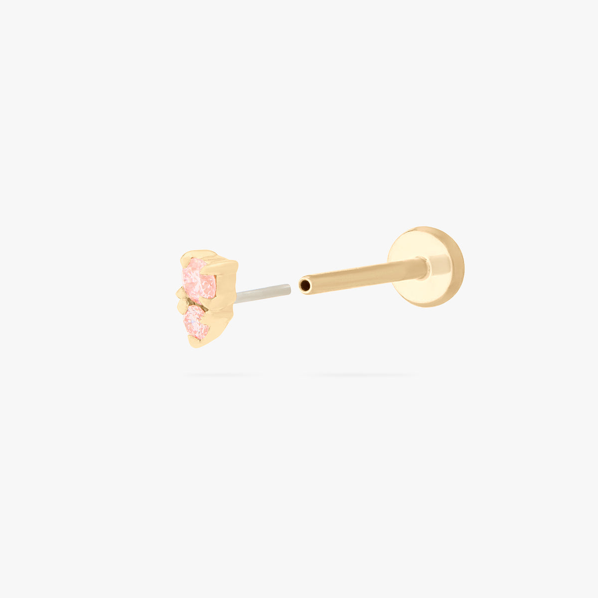 This image shows a flatback stud made of 14K gold with a round pink diamond stone stacked over a small triangular pink diamond stone and the gold-toned labret back removed. 