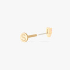 This image shows a flatback stud made of 14K gold with a round pink diamond stone stacked over a small triangular pink diamond stone facing away from the camera with the the gold-toned labret back removed. 