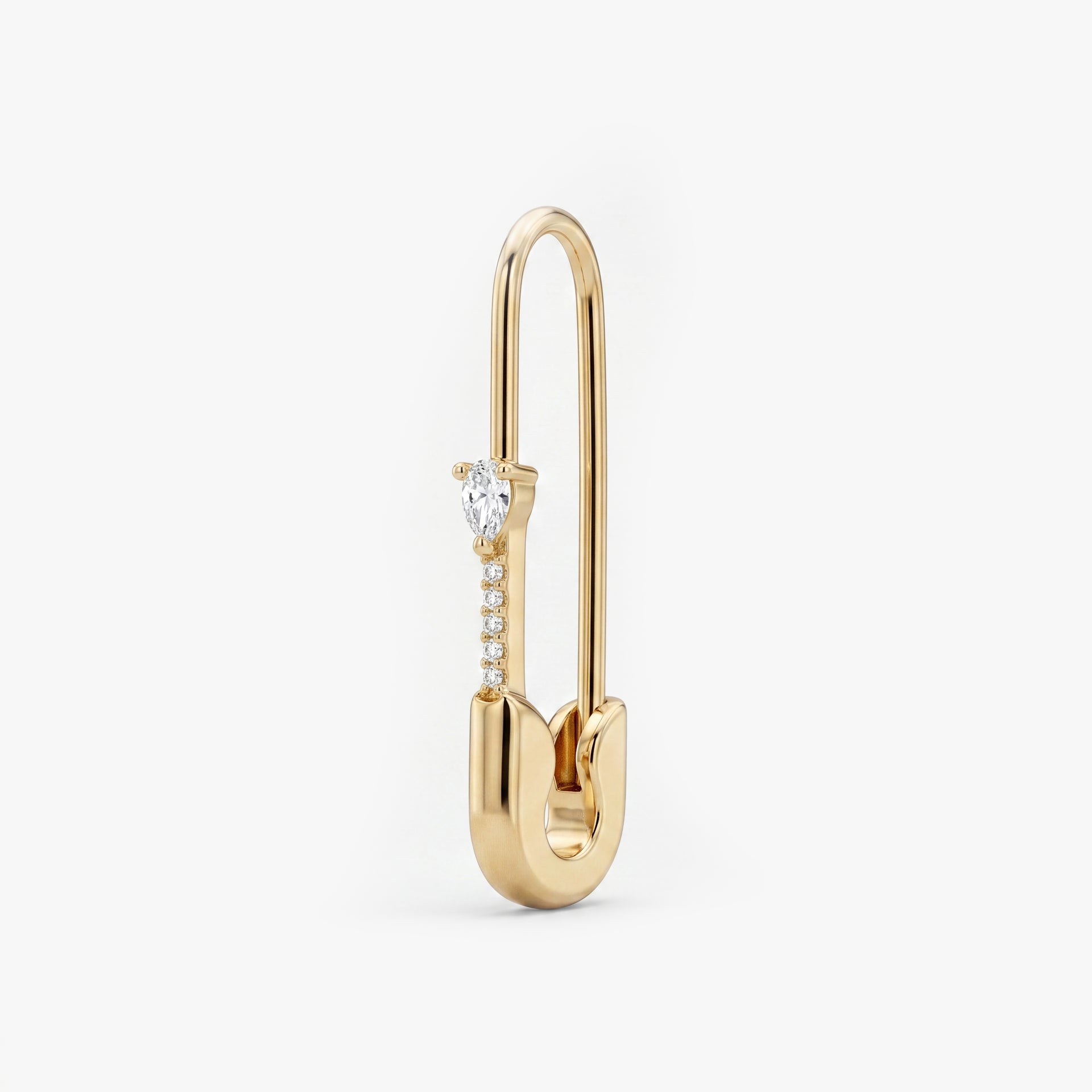 This is an image of a 14k yellow gold plated brass earring shaped like a safety pin with a clear, pear cut CZ stone and 5 clear accent stones below the pear CZ. - Main view