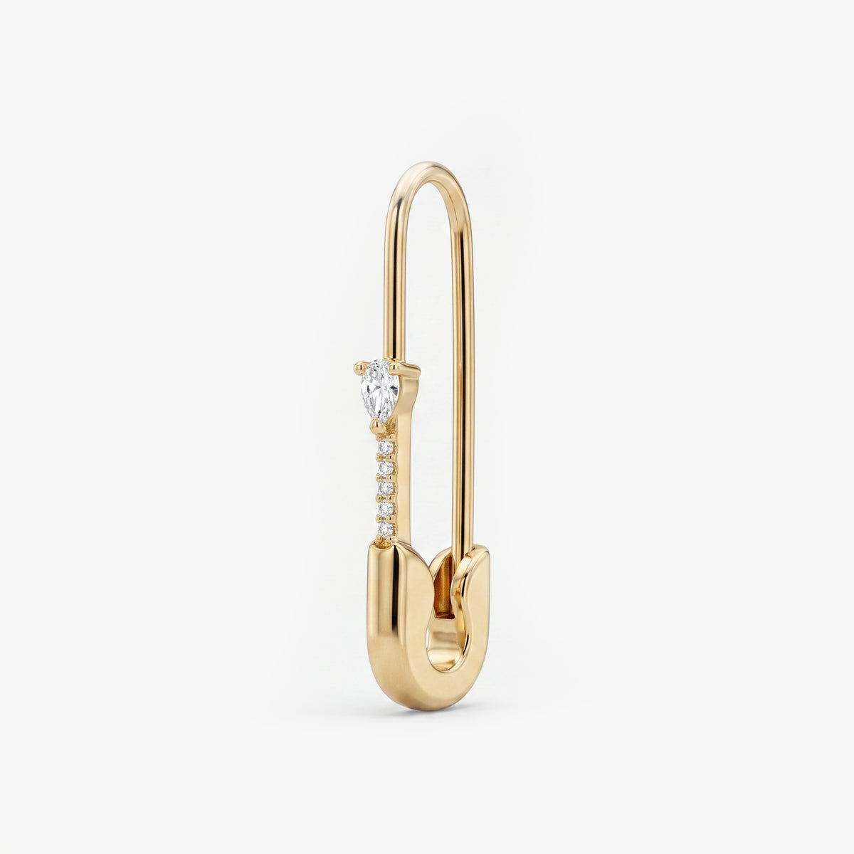 This is an image of a 14k yellow gold plated brass earring shaped like a safety pin with a clear, pear cut CZ stone and 5 clear accent stones below the pear CZ. 