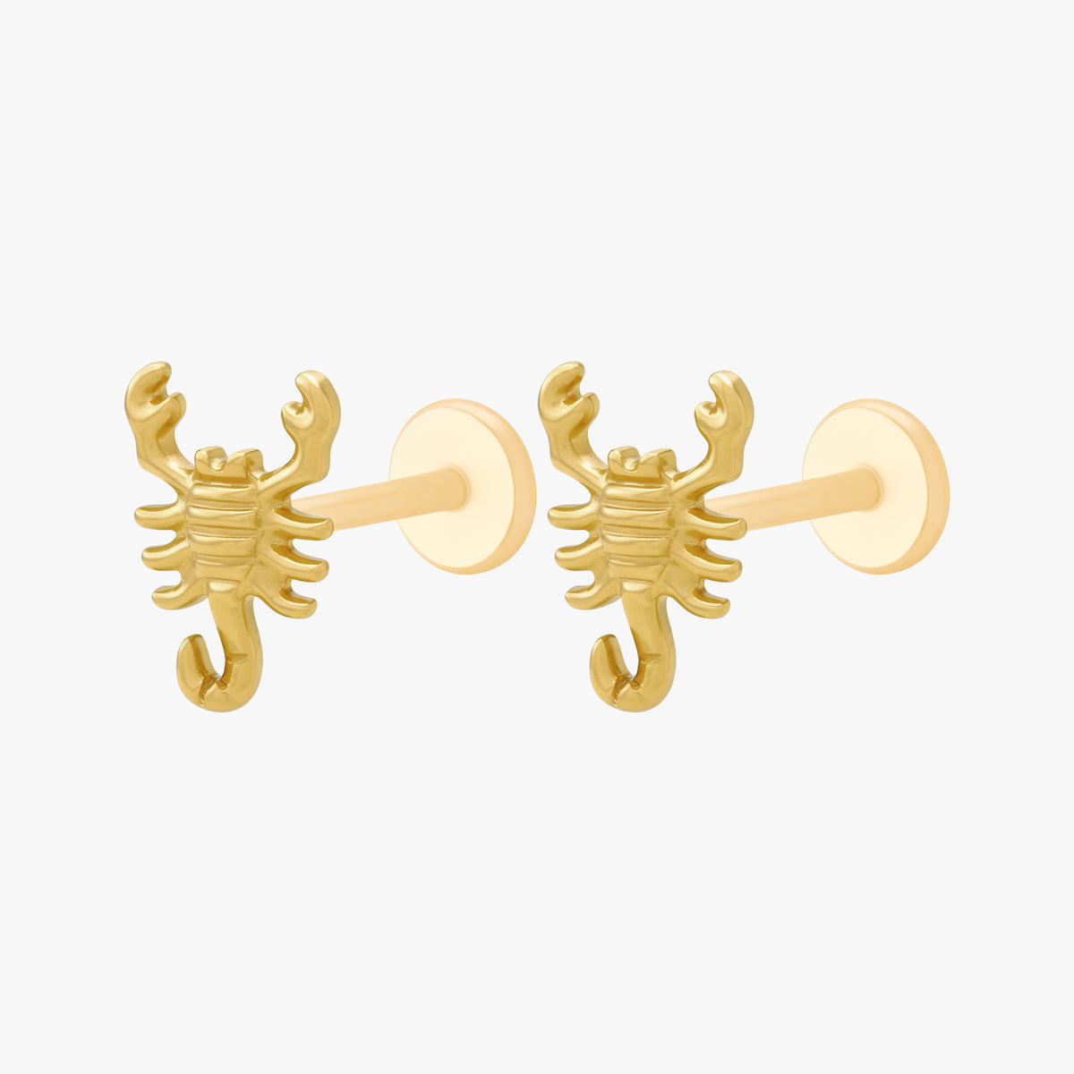 This image shows the side view of a pair of the golden titanium scorpion flatbacks 