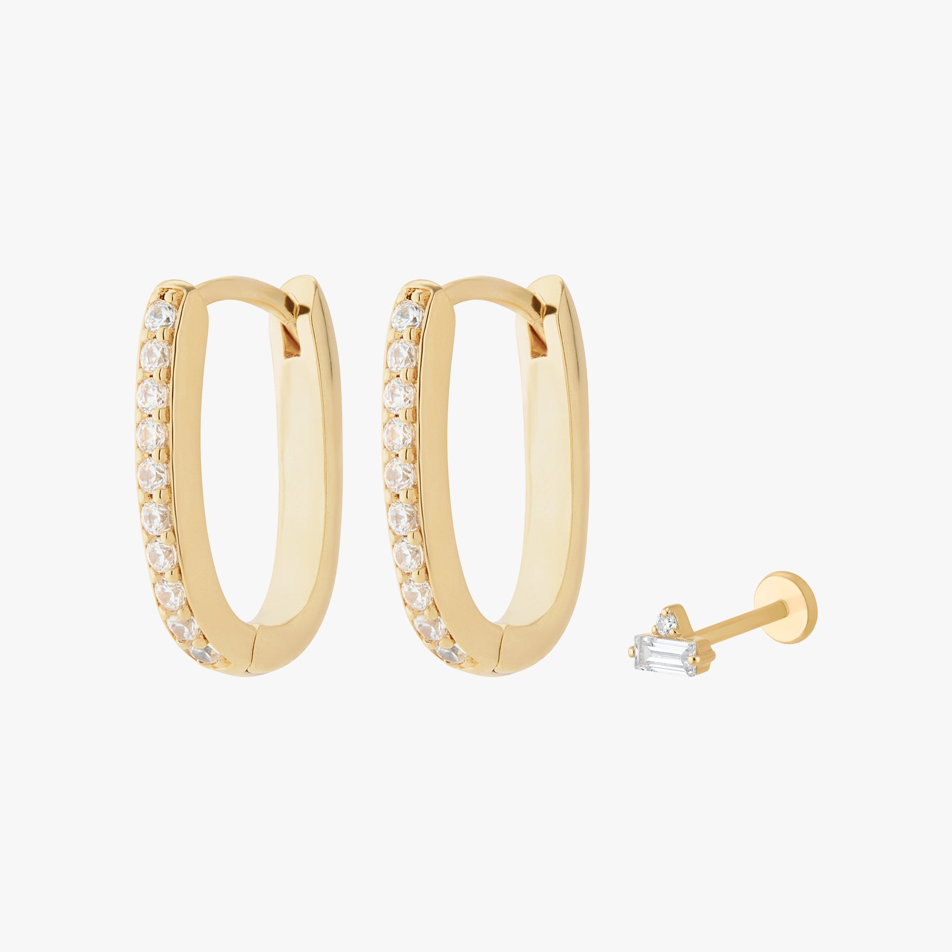 Gold earscape featuring a pair of Pave Oval Hoops and a micro stacked baguette flatback stud with clear stones - Main view
