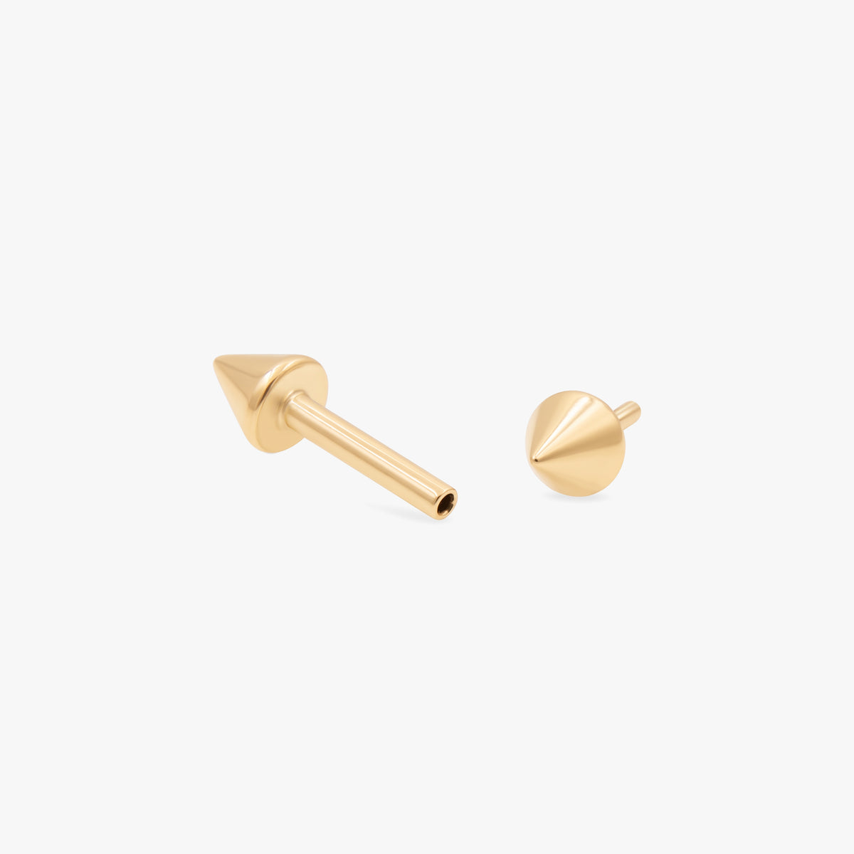this image shows the side view of the 14k yellow gold plated reversible spike flatback separated from labret