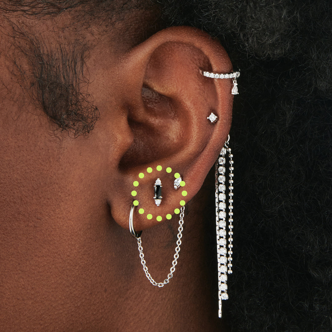 A black baguette-shaped CZ stud with two silver/clear CZs on the end of the baguette on ear. [hover] color:null|silver/black