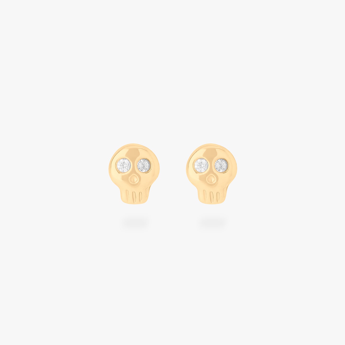 micro cz skull stud in gold with cz accent eyes [pair] color:null|gold/clear