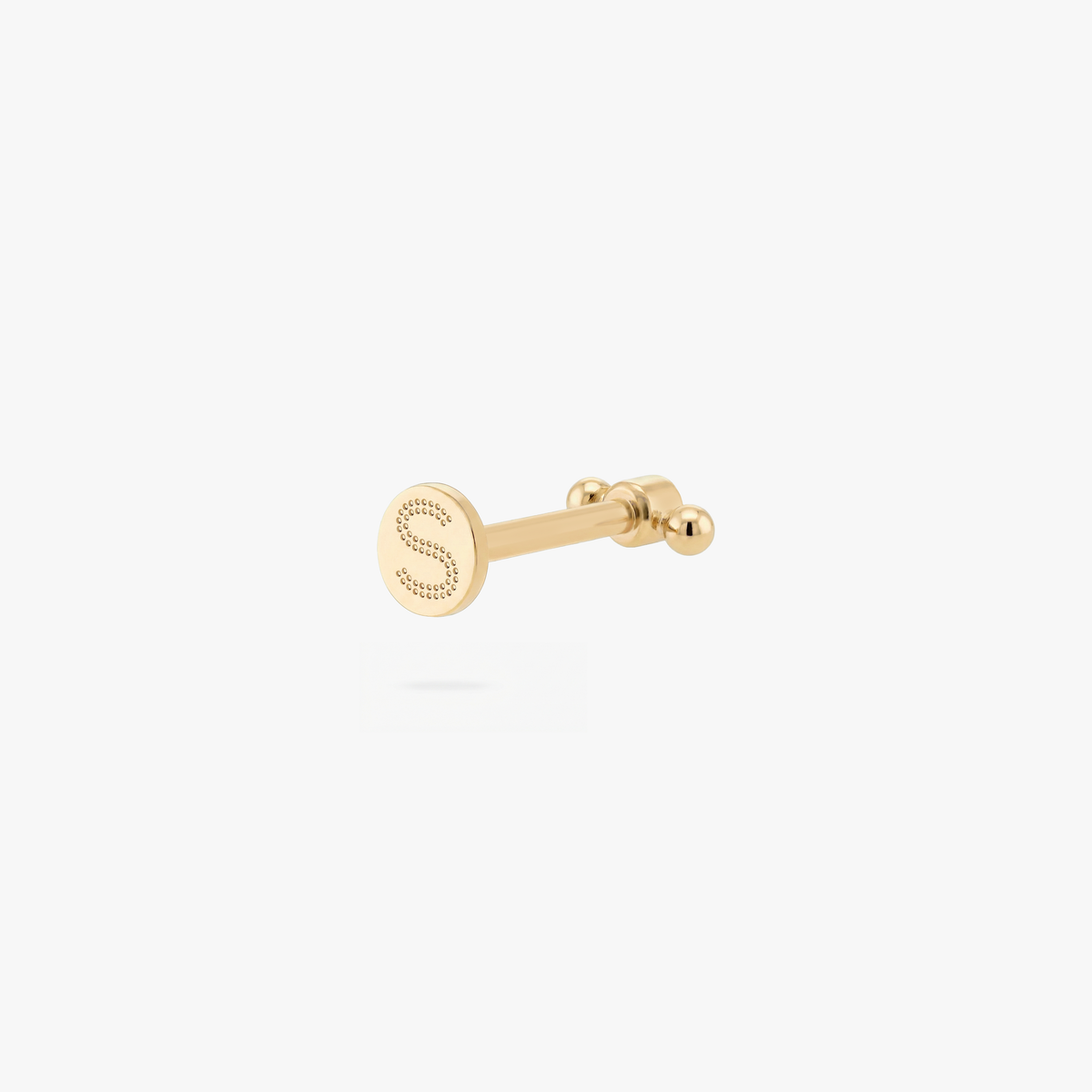 Back angle of a gold flatback earring with an 'S' engraving on the post on a white background