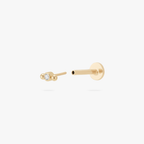 Open angle of a gold flatback stud with a small center bezel stone and 2 small balls on either side