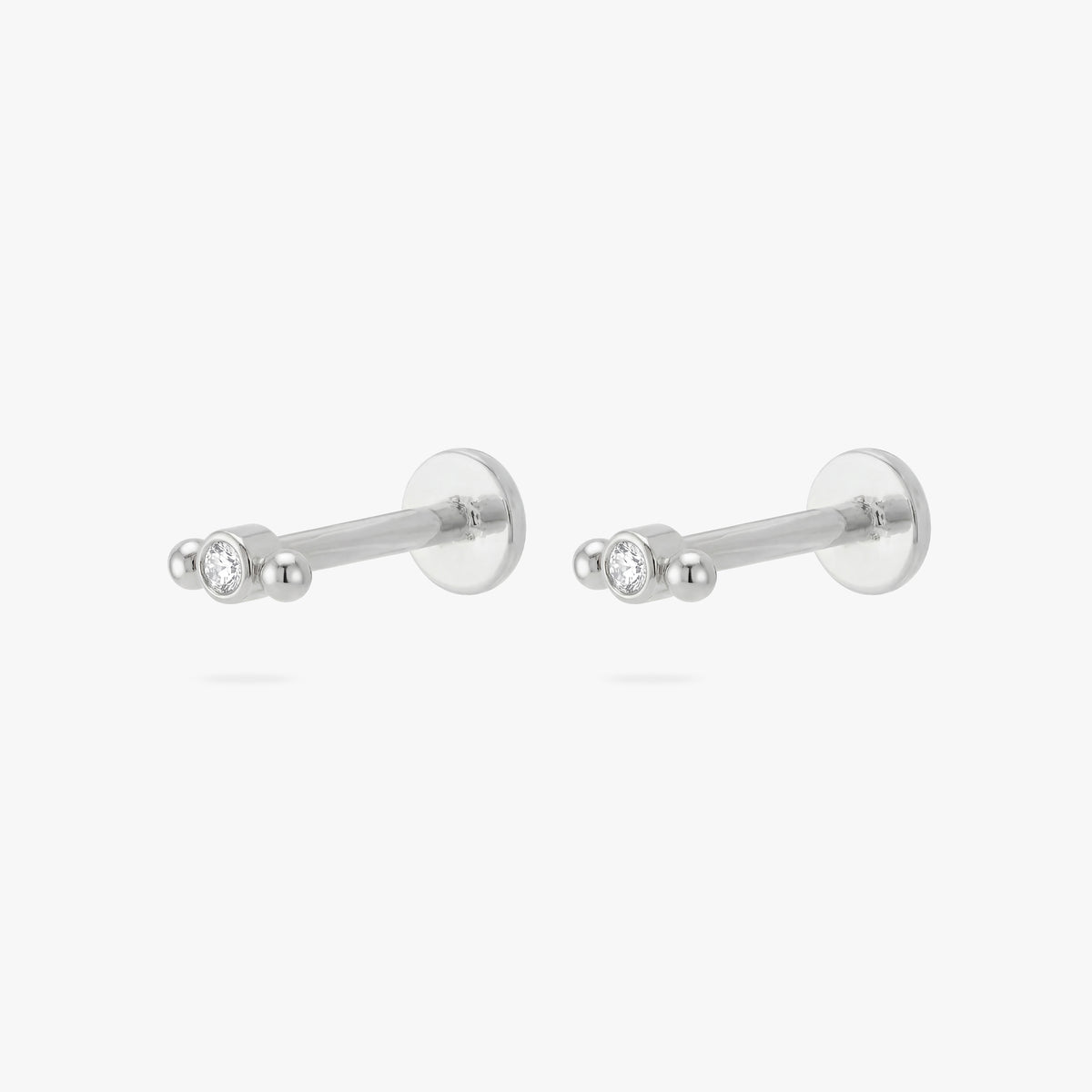 Pair of silver micro bezel cluster flatbacks with a small bezel stone in the middle and 2 small balls on either side