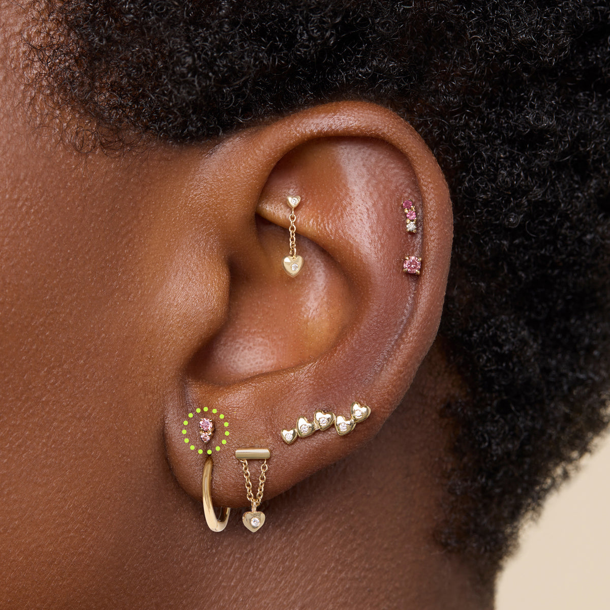 This image shows a flatback stud made of 14K gold with a round pink diamond stone stacked over a small triangular pink diamond stone on ear. 