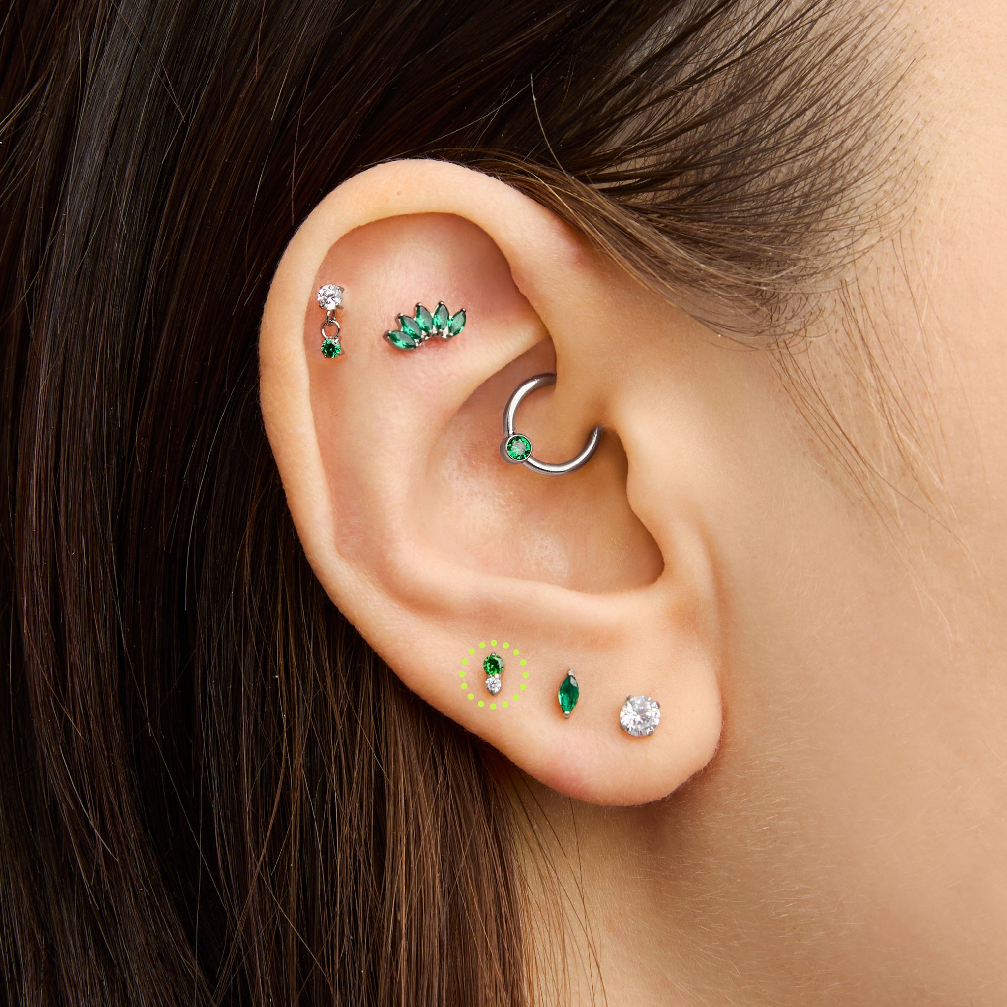 This is an image of a silver flatback stud composed of titanium with a green cz stone stacked over a clear cz stone on ear. [hover] color:null|silver/green