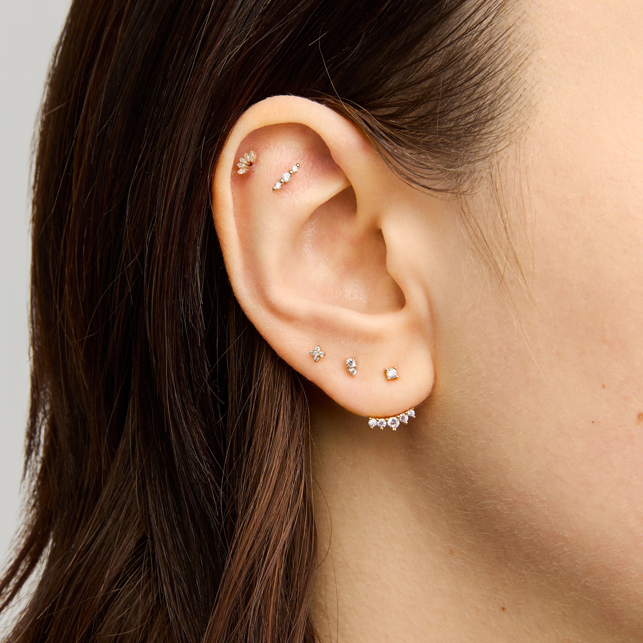 This is an image of a gold-toned jacket for a stud that is composed of CZs in the shape of a crown. [hover] color:null|gold/clear