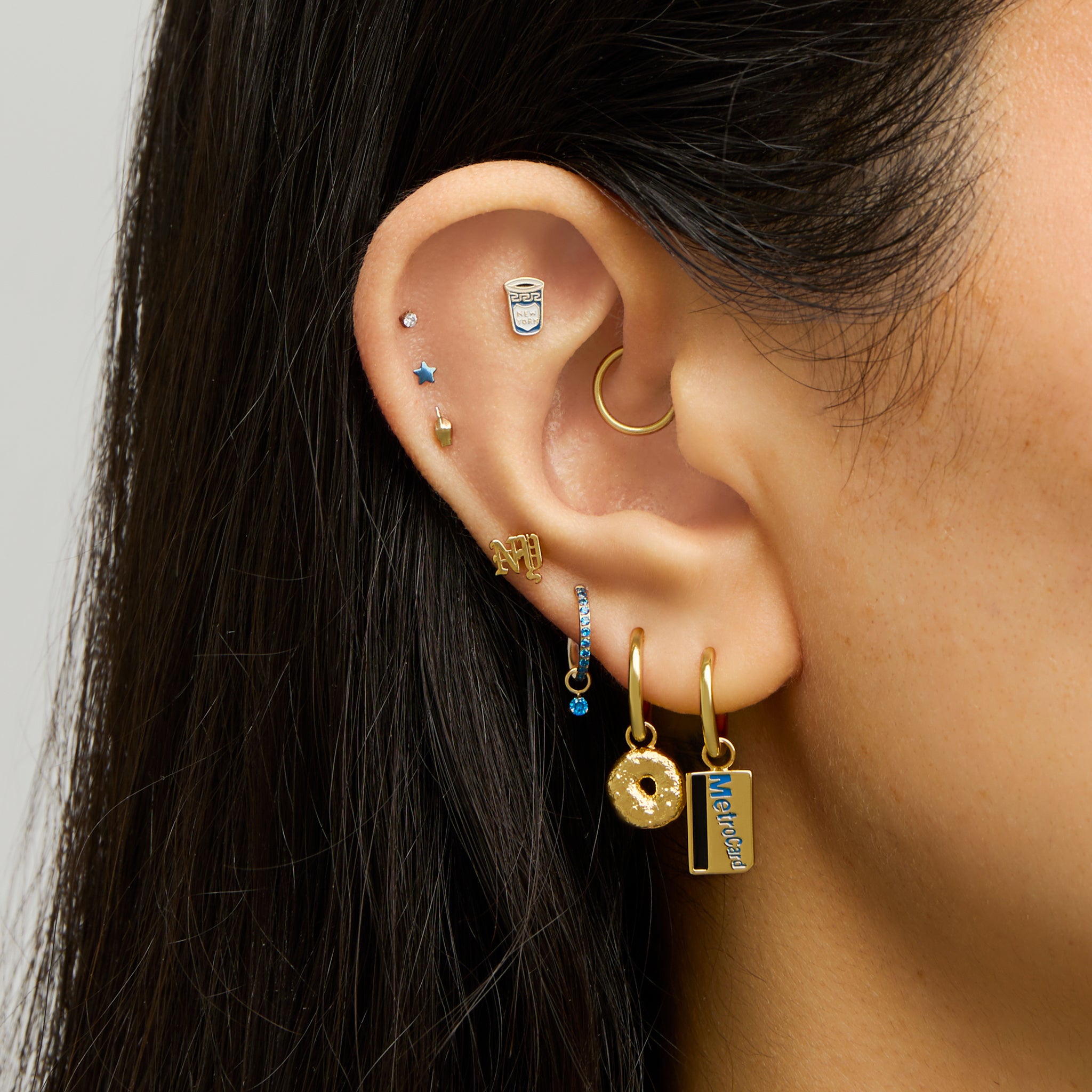 This is a small gold huggie with a metro card charm dangle [hover] color:null|gold