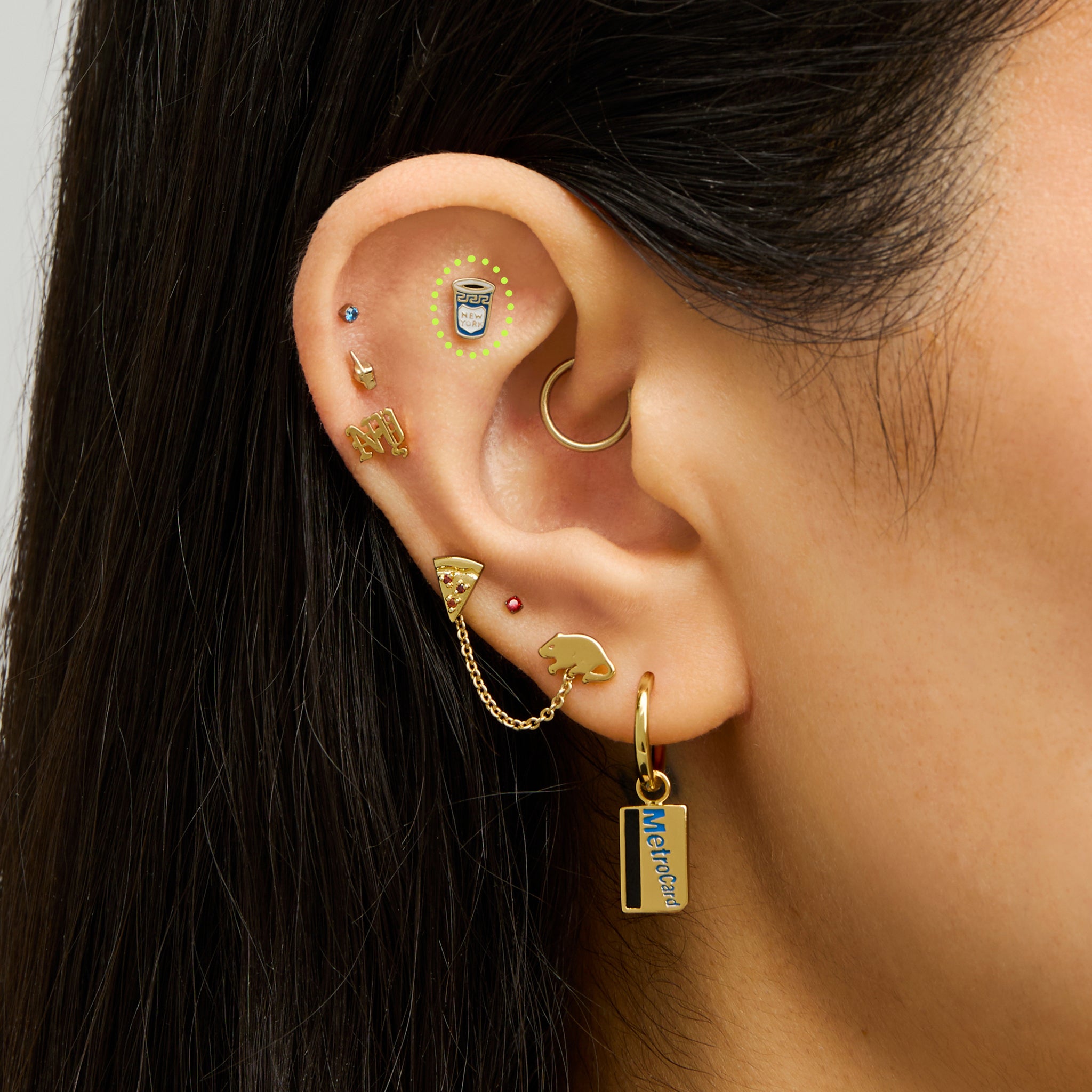 This is an image of a gold-toned flatback stud in the shape of a coffee cup with blue and white enameling on ear. [hover] color:null|gold/blue