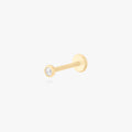 This is an image of a 14k gold flatback with a bezel setting and clear stone on ear. color:null|14k gold