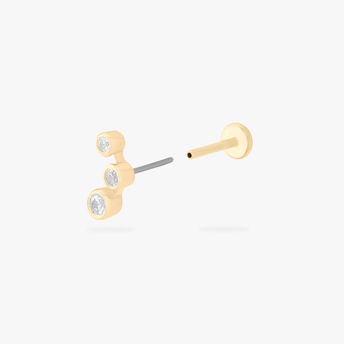 This is an image of a 14k gold flatback stud with 3 clear cz bezels in a cluster shape. color:null|14k gold/clear
